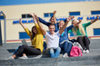 © .shock - students outside sitting on steps