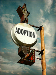 aged and worn vintage photo of adoption sign