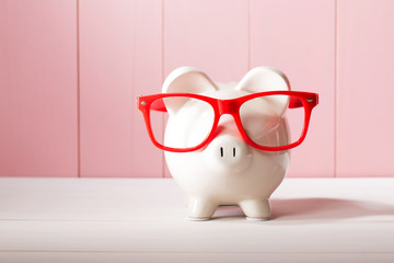 Wall Mural - Piggy bank with red glasses