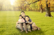 © Creativa Images - Happy children and father sitting at autumn park