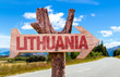 Lithuania wooden sign with road background