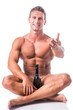 © theartofphoto - Muscular shirtless man with champagne bottle