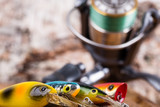 Fototapeta Młodzieżowe - closeup fishing baits wobblers with reel