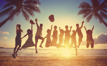 Group Of People Jumping At Beach
