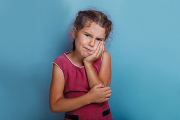 Wall Mural - Girl European  appearance decade toothache on a blue background