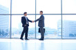 © lenets_tan - Full length image of two successful business men shaking hands