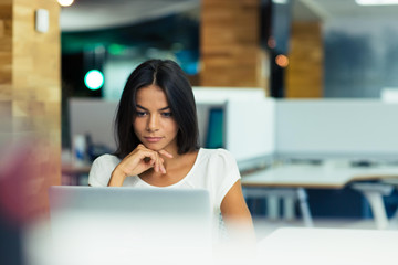 Wall Mural - Businesswoman using laptop in office