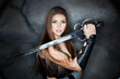 Beautiful girl holding a steel sword in his hand.