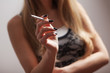 Close up image of woman holding cigarette