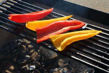 Wall Mural - Red and yellow sliced pepper on a grill