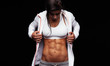 © Jacob Lund - Fitness woman looking at her muscular abs