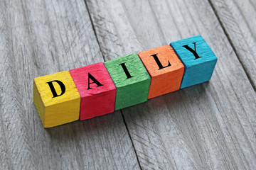 Wall Mural - word daily on colorful wooden cubes