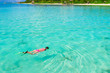 © travnikovstudio - Young girl snorkeling in tropical water on vacation
