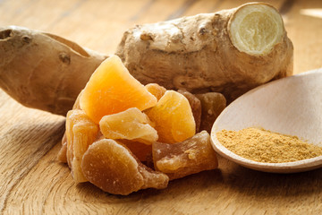 Wall Mural - Candied fresh and ground ginger on rustic table