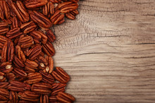 Pecan Nuts On Old Wooden Background. Top View