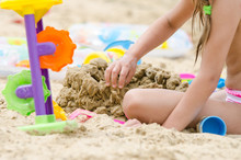 The Girl Builds A Sand Castle