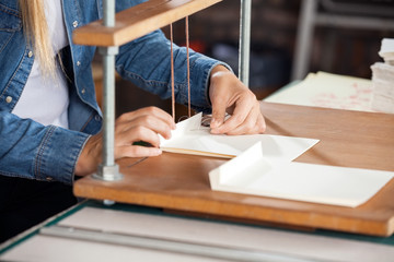 Female Worker Binding Papers At Workbench