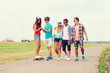 © Syda Productions - group of smiling teenagers with skateboards