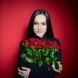 © Khorzhevska - Beautiful Woman with Fresh Red Roses. Girl and Flowers over Red