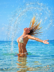  blonde woman  in the water waving hair