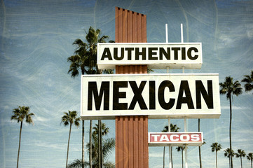 aged and worn vintage photo of mexican food sign with palm trees