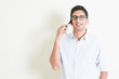 © WONG SZE FEI - Casual business Indian male calling on smartphone