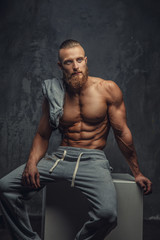 Wall Mural - Portrait of muscular shirtless man with beard.