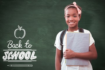 Sticker - Composite image of little girl holding folders in school 