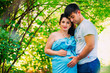 © davit85 - Beautiful pregnant couple relaxing outside in the park.
