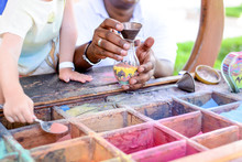 Boy Creating Colorful Sand Art