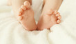 Soft photo closeup comfort baby feet on the bed at home