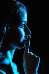 Contour of a beautiful young woman in blue light showing the sil