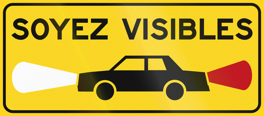 Sticker - Warning road sign in Quebec, Canada - Turn on lights. Soyez visibles means be visible