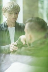 Wall Mural - Psychiatrist comforting military patient