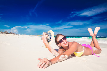 Young woman enjoying sunny day at tropical beach