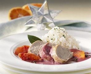 Wall Mural - Pork fillet in juniper cream sauce with blood oranges and rice