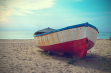 An Abandoned Deteriorated Boat Aground In The Beach. Copy Space For Editor's Text.