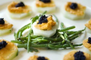 Wall Mural - Appetisers: cucumber, spicy cream and caviar on samphire