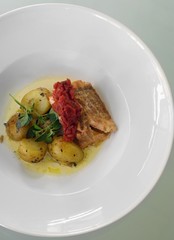 Wall Mural - Salmon in butter sauce with potatoes and tomatoes