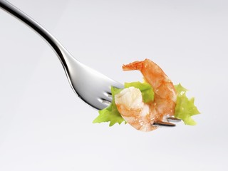 Wall Mural - A prawn and a lettuce leaf on a fork