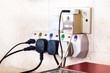 © ThamKC - Multiple electricity plugs attached to multi adapter risk overload and is dangerous