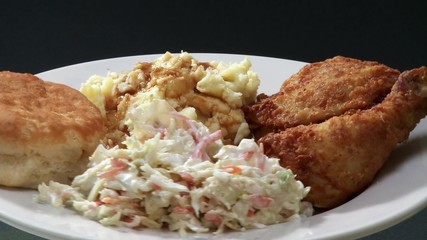 Wall Mural - Deep-fried chicken pieces with coleslaw and potato salad