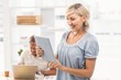 © WavebreakMediaMicro - Smiling businesswoman scrolling on a tablet