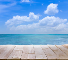 Wood Table With Blur  Seascape And Blue Sky Background