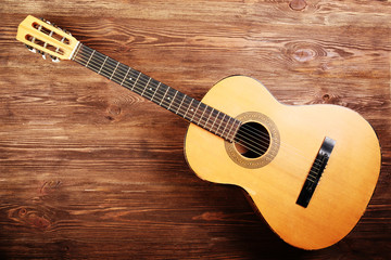 Poster - Acoustic guitar on wooden background