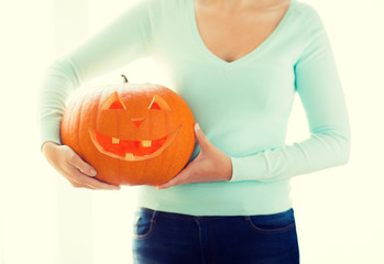 Wall Mural - close up of woman with pumpkins at home