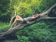 © LoloStock - Sensual young woman on fallen tree in forest