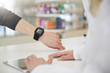 © Westend61 - Customer showing female pharmacist his smartwatch