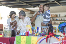 Three Generations Family Having A Garage Sale