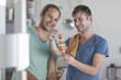 © Westend61 - Happy gay couple preparing meat skewers in kitchen